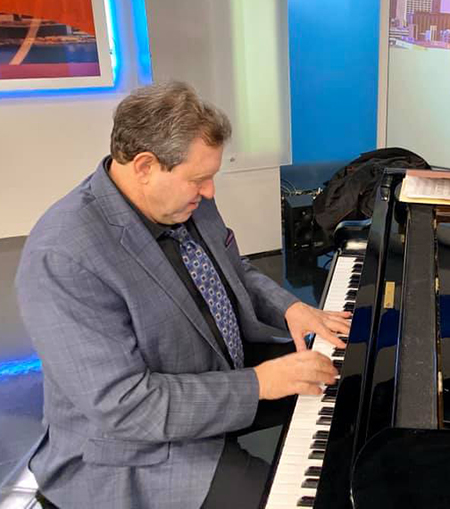 Bruce Barth playing piano in a television studio.