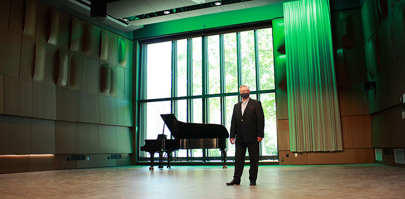 Photo: James Forger, dean MSU College of Music wearing a mask, standing in the Dick and Ruth Charles Atrium in the Billman Music Pavilion.
