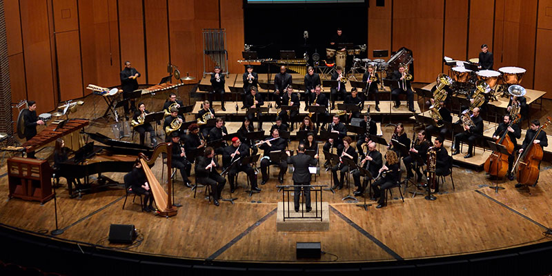 MSU Wind Symphony conducted by Kevin Sedatole on the stage of Cobb Great Hall of the Wharton Center.