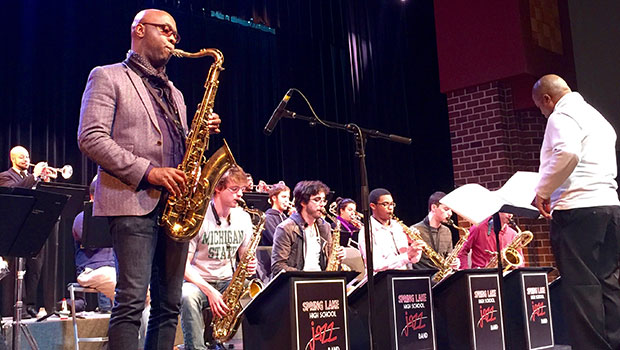 Tim Warfield, Jr. and Director of Jazz Studies Rodney Whitaker work and perform with students at Spring Lake High School. image