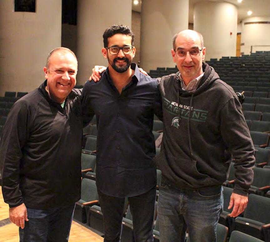 Posing for a picture after a rehearsal in Cobb Great Hall of Wharton Center for Performing Arts, (left to right) Kevin Sedatole, conductor, Manuel Alejandro Rangel, maracas; Ricardo Lorenz, composer.