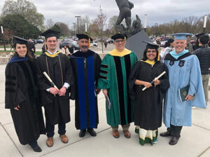 People smiling after a graduation ceremony 