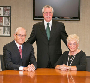 Byron and Dee Cook smiling with Jim Forger 