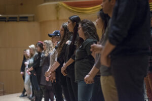 side view of college students in a line on a stage