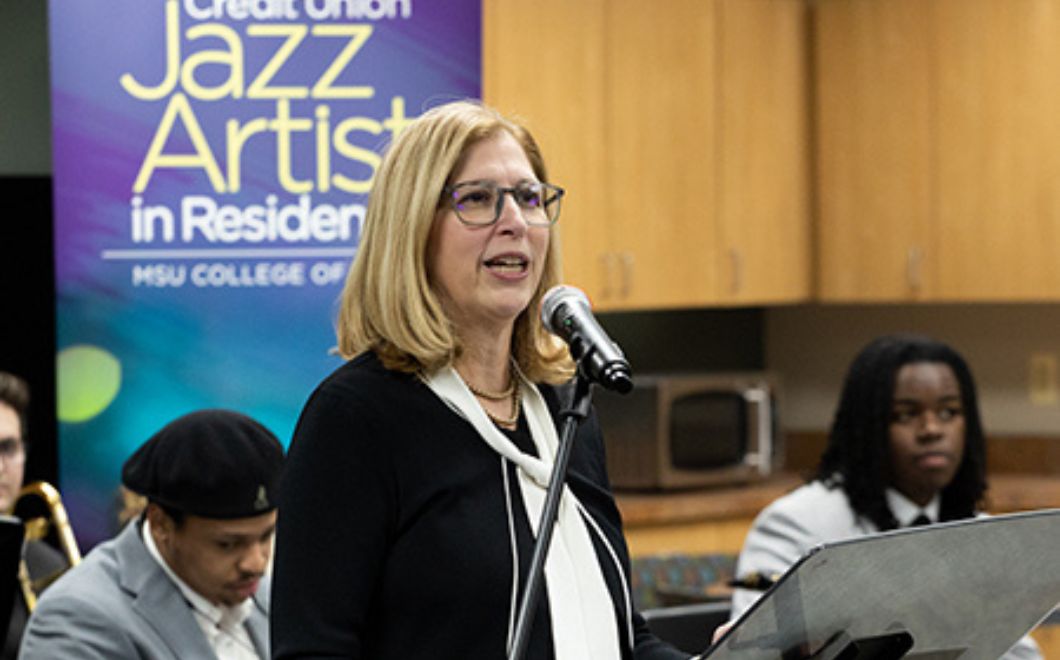 MSU Interim President Teresa K. Woodruff, Ph.D. addresses the gathering at the MSU Community Music School-Detroit on December 7, 2022, to celebrate the creation of the MSUFCU DREAM Fund.