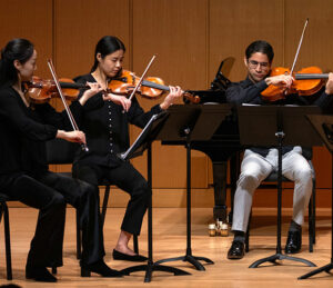 String quartet performs on stage during an annual chamber music competition.