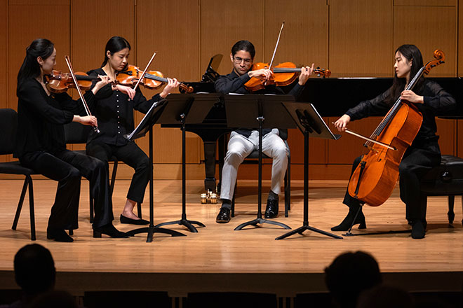 String quartet performs on stage during an annual chamber music competition.