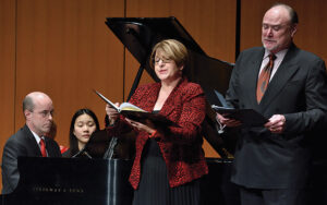 Jane Bunnell and Marc Embree performing on stage, accompanied by Elden Little