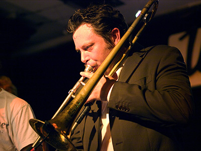 close up of man playing trombone