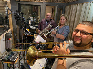 Photo of three people in a music studio