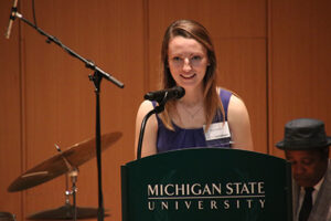 Nicole Sanford speaking at a podium