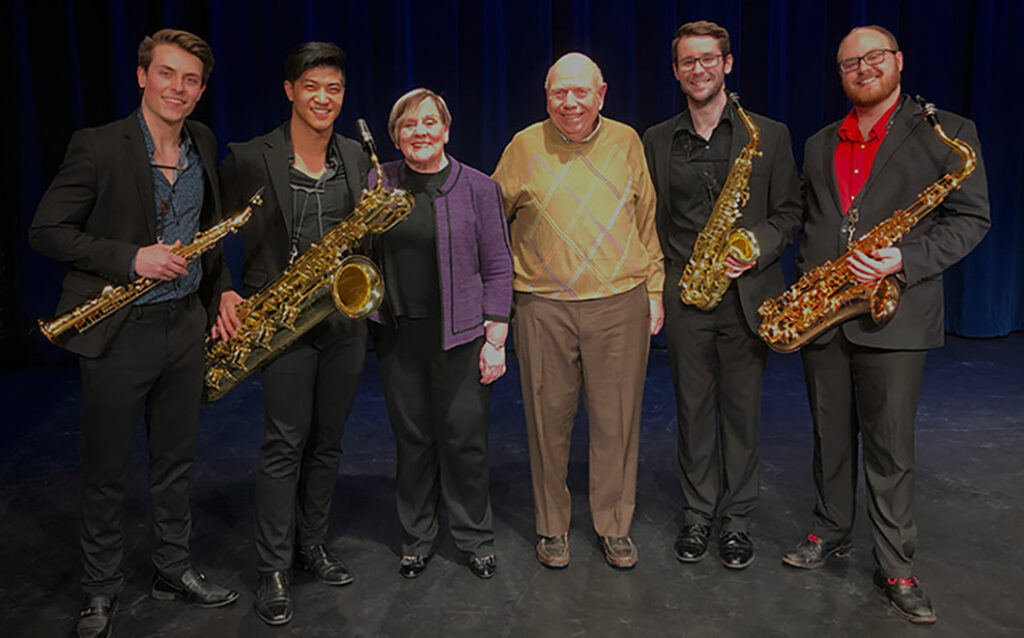 Group photo of saxophone quartet and MSU alumni