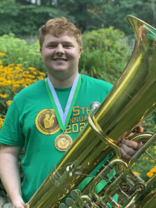 Ben McWilliams smiling with his tuba