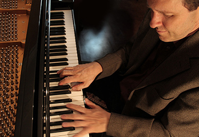 close up from above of man playing piano