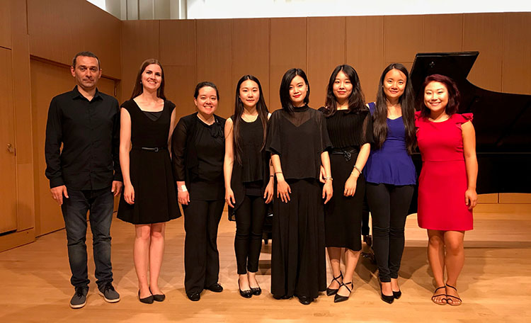 Group of Celebrating the Spectrum program assistants smiling on stage 