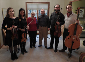 Group photo of people smiling with instruments