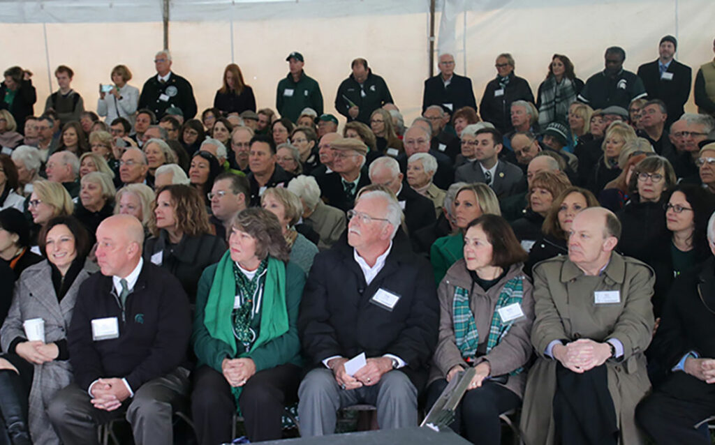 Audience members sitting down at the celebration of the Billman Music Pavilion. 