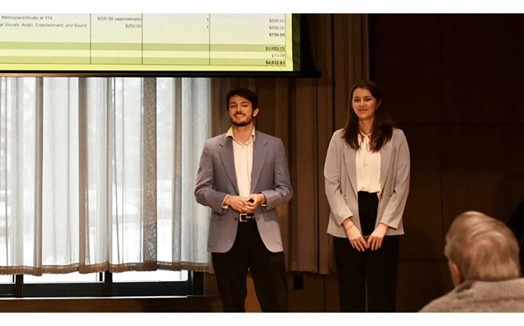 Two MSU students standing onstage 