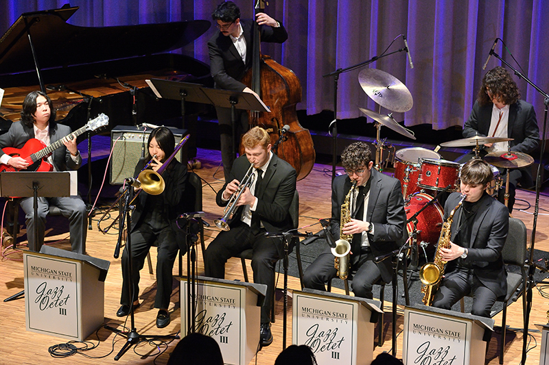 nine piece jazz band performing on stage