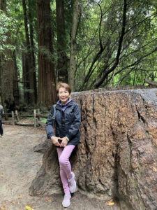 Photo of Jenny Chung with a Redwood tree.