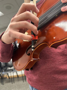 Up close photo of a hand playing the violin 