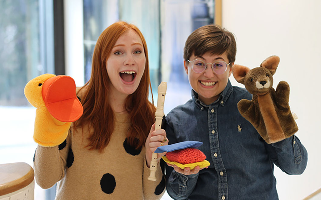 Photo of Maria and Lizabeth holding up puppets