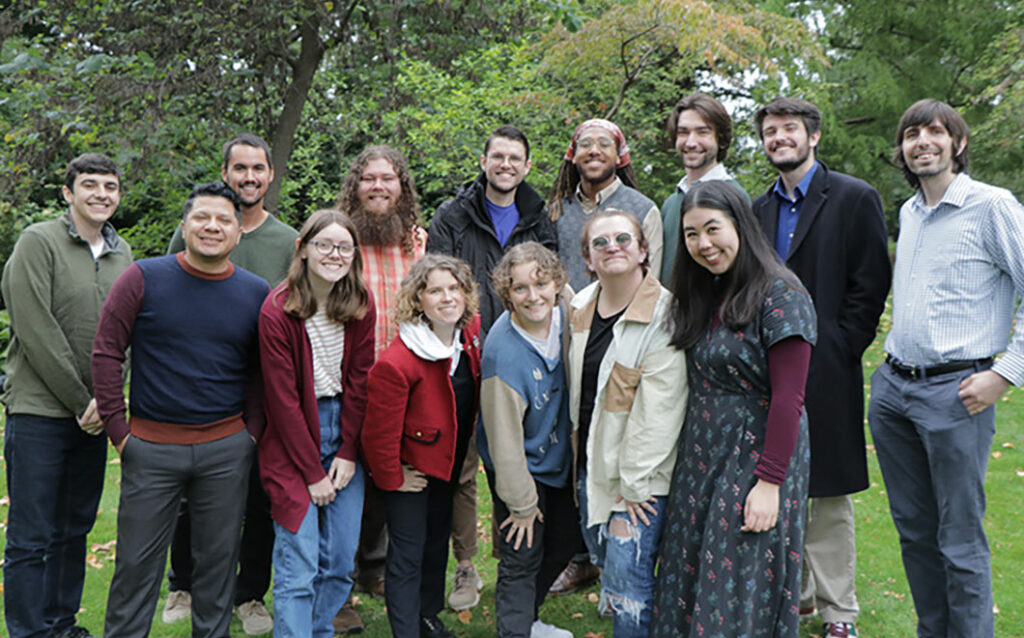 Group of students and faculty smiling outside