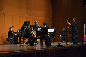 Ensemble performing on stage 