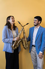 Two students smiling with their saxophones 