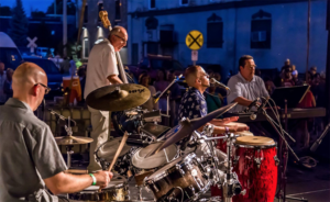 Band performing with blue lighting in the background 