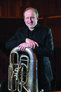 Philip Sinder headshot with tuba