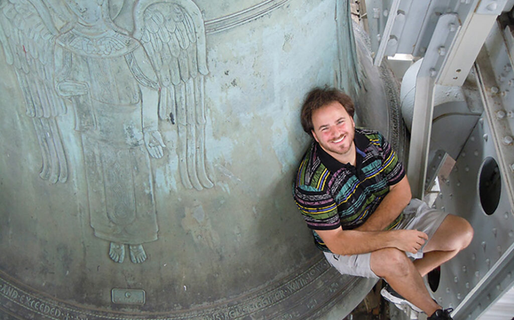 Jon Lehrer sitting on a bell