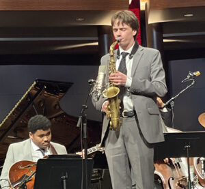 Thomas Noble playing saxophone on stage 