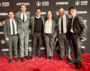 People smiling on a red carpet