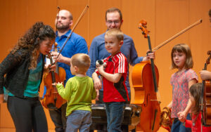 Sensory Friendly Spartan Concert. Musicians and young children on stage together.