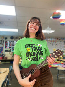 Teacher smiling with ukulele