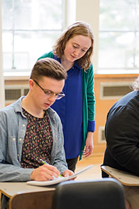 Teacher assisting student in theory classroom