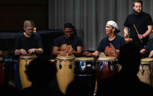 African Diaspora Percussion Ensemble performing on stage