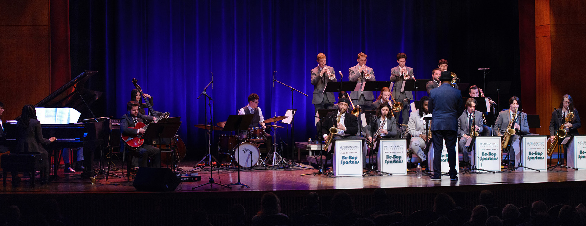 Jazz Orchestra students performing on stage, lead by Rodney Whitaker.