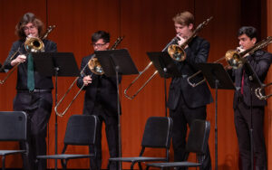 Trombone Ensemble. Four MSU Trombone students playing on stage.