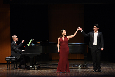 Pianist, left, performs with two singers, right