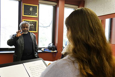 opera professor gives instruction to a student 