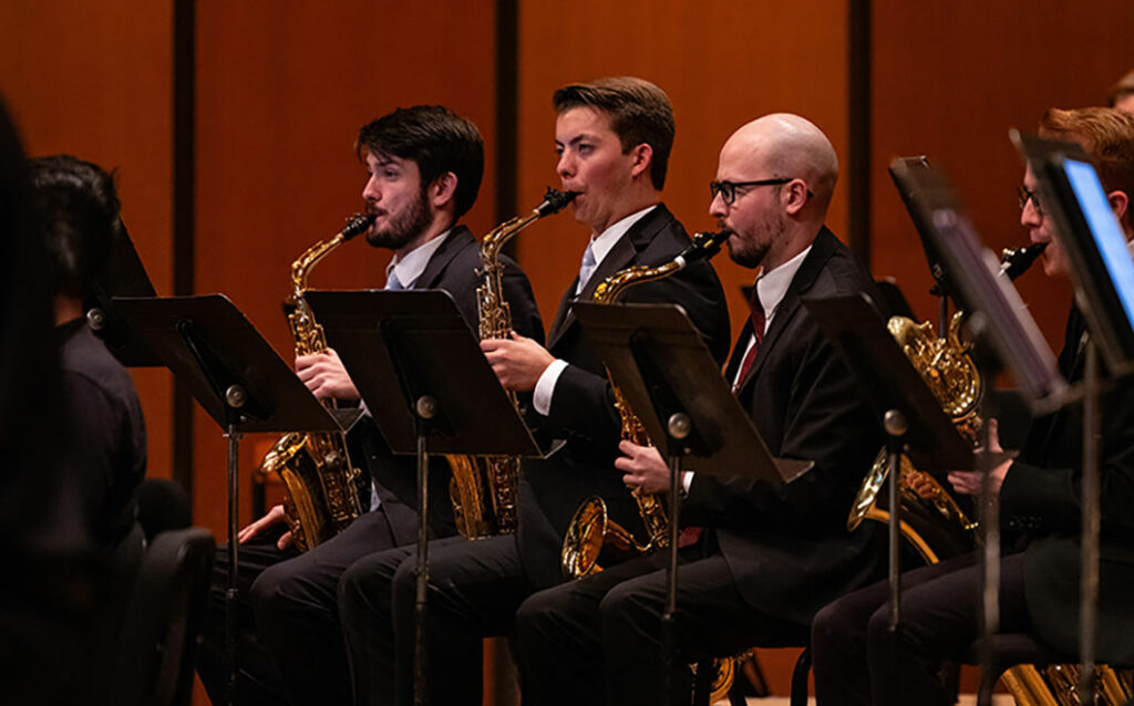 Three MSU music students playing the saxophone 