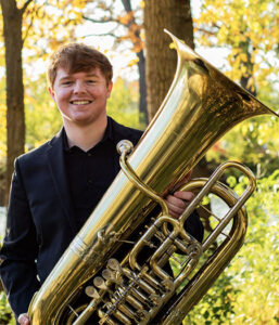 Ben McWilliams headshot with tuba 