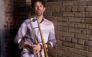 Ryan Keberle holding trombone.