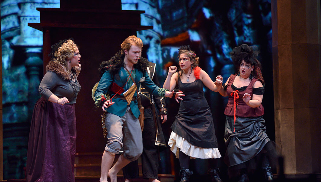 Four members of the 2014 MSU Opera Theatre production of The Magic Flute act out a scene on stage of the Fairchild Theatre