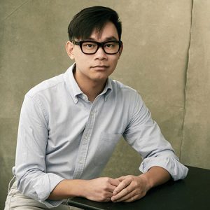 portrait of Viet Cuong, solemn expression, looking at camera and wearing glasses