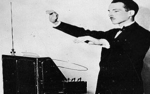 a man in a suit playing a theremin