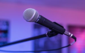 a microphone in front of a pink and white background