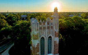 Aerial photo of the top of Beaumont Tower with the sun setting in the background